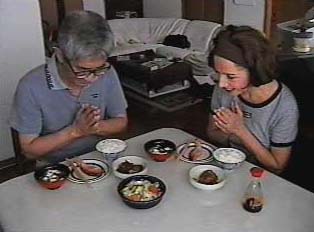 Two people bowing before a meal