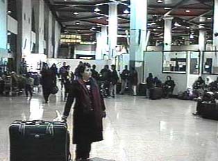A person in an airport with a large piece of luggage