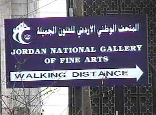 A sign with an arrow that reads 'Jordan National Gallery of Fine Arts; Walking Distance'