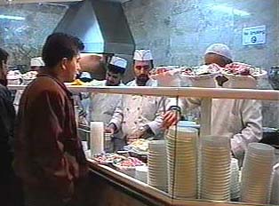 A person ordering food at a restaurant counter