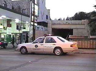 A white police car parked by the street