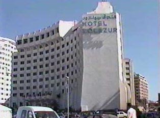 A large, white, several-story hotel