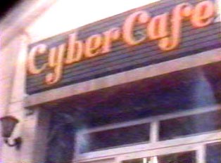 A sign for a cyber cafe