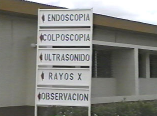 A sign pointing to different hospital departments