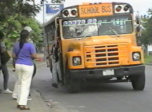 A yellow school bus pulling up