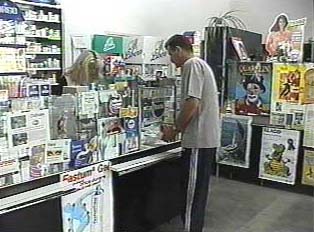 A person making a purchase at a pharmacy counter