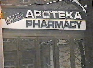 A black and white sign indicating a pharmacy