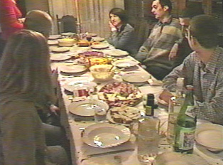 A family sitting at the dinner table for a Saint's Day dinner