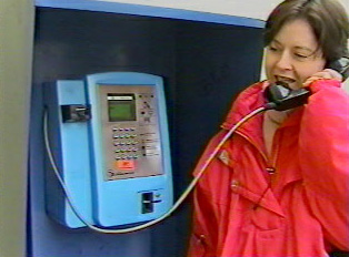 A woman using a pay phone