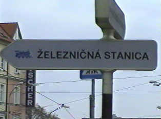 A sign pointing to a train station
