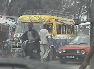 A colorful van driving through traffic
