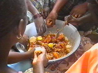 People sharing a large common bowl of food