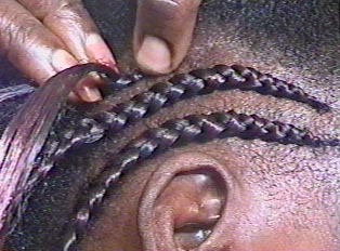 A person getting their hair braided