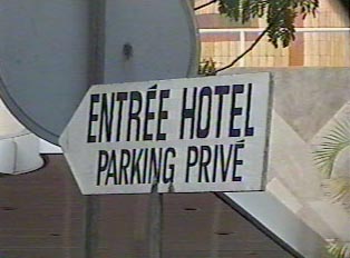 A sign to a hotel entrance and private parking