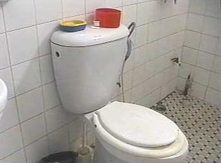 A toilet inside a tiled bathroom