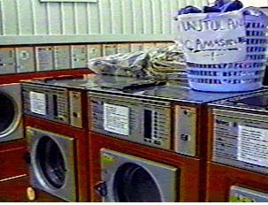 A line of red washing machines in a laundromat