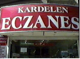 A red and white sign for a pharmacy
