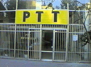 A yellow sign with black letters indicating a post office