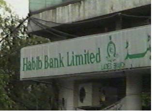 Green letters on a stone sign that read 'Habib Bank Limited'
